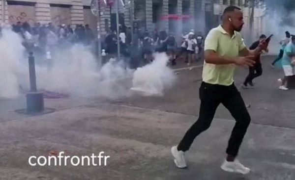 Police throw tear gas at protesters in Marseille.