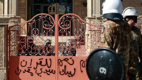 Iraqi security forces stand outside an entrance to the Swedish embassy in Baghdad, after protesters stormed the compound.