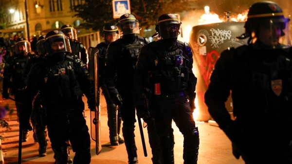 Police officers walk near a protest in Paris on June 30, 2023.