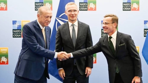 Turkish President Recep Tayyip Erdogan and Swedish Prime Minister Ulf Kristersson shake hands with NATO chief Jens Stoltenberg looking on. — courtesy EPA