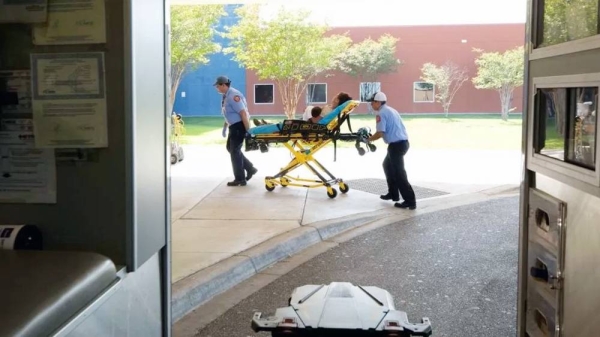 A woman suffering from heat exhaustion is taken into a medical center in Texas. — courtesy Reuters