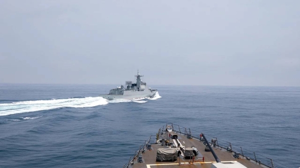 The Chinese warship Luyang III sails near the American destroyer USS Chung-Hoon, as seen from the deck of US ship, in the Taiwan Strait on June 3, 2023, in this handout picture.