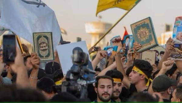 Iraqis raise copies of the Quran, Muslims' holy book, during a protest in Tahrir Square, Thursday، July 20, 2023 in Baghdad, Iraq. The protest was in response to the burning of Quran in Sweden
