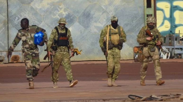 This undated photograph handed out by French military shows three Russian mercenaries, right, in northern Mali. -