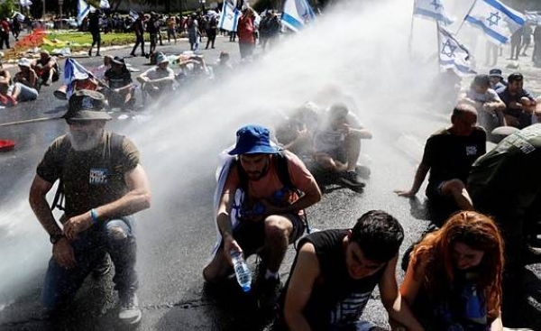 Police use water cannon to disperse protesters blocking a highway in Jerusalem.