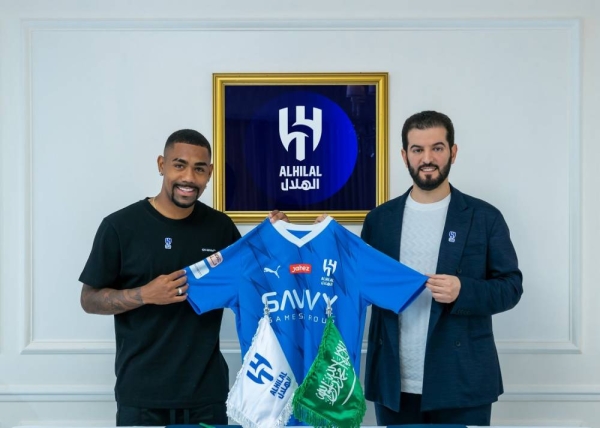 Al-Hilal jersey being handed to Malcolm Filipe de Oliveira (Photo courtesy Al-Hilal Media Center)