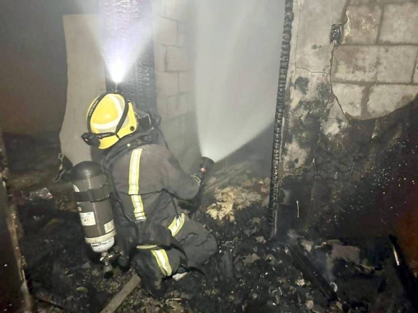 A Civil Defense team member at the scene of fire in Al-Ahsa.