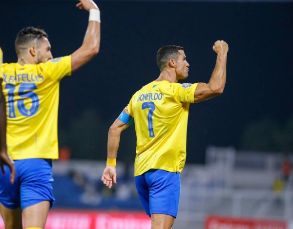 Cristiano Ronaldo celebrates with Alex Telles after scoring the goal for Al-Nassr