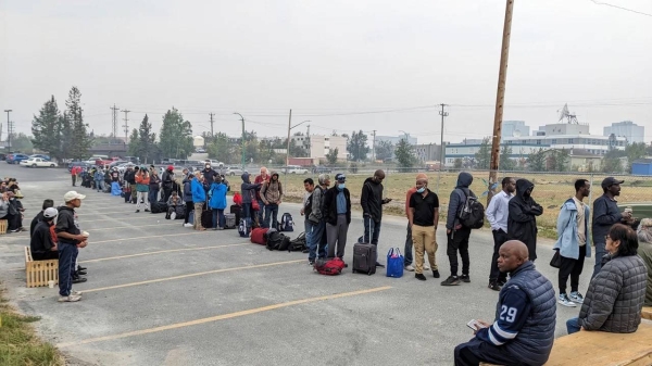 People line up in Yellowknife to register for an evactuation flight on August 17, 2023.