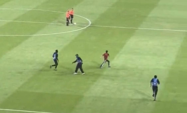 Screenshot of 3 people invading the pitch during a football match between Al Nassr and Al Taawoun at Alawwal Park stadium on Friday. (@Al_NasrKSA)