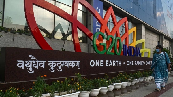 A woman passes the G20 logo in New Delhi, India, on September 5.