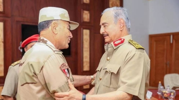 Gen Khalifa Haftar greets Egypt's army chief of staff Lt Gen Osama Askar