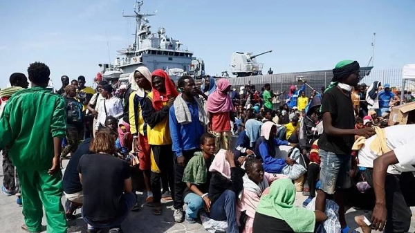 Migrants prepare to board an Italian Navy ship to be taken away from Lampedusa Island after being rescued at sea, Friday, Sept. 15, 2023.
