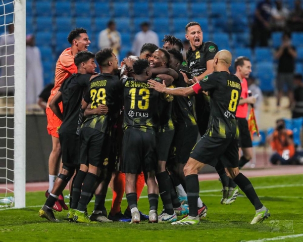 Al-Ittihad players celebrate their heroic goalkeeper Abdullah Al-Mayouf after he saved four penalties.