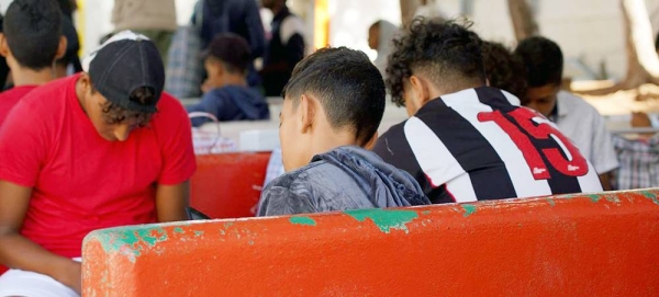 Unaccompanied migrant adolescents wait to be transferred to a reception facility in Lampedusa, Italy, after crossing the Central Mediterranean Sea. — courtesy UNICEF/Niccolò Corti