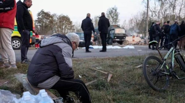 Local residents at the site of a military strike in the village of Hroza, northeastern Ukraine on 5 October 2023