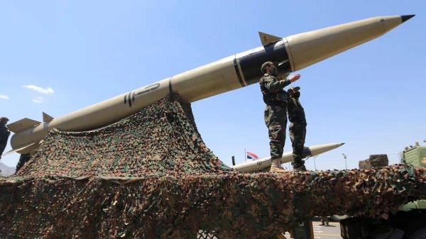 Houthi soldiers stand guard on a missile carrier during an official military parade in Sanaa, Yemen