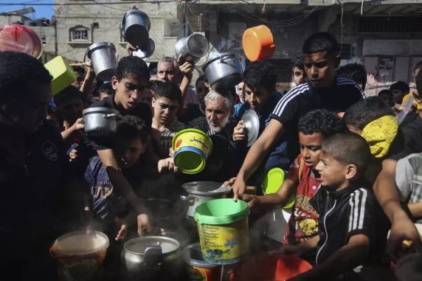 Palestinians crowded together as they wait for food distribution in Rafah, southern Gaza Strip, Wednesday, Nov. 8, 2023