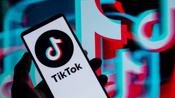 TikTok displayed on a smartphone with TikTok Icon seen in the background