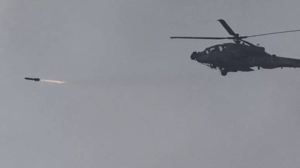 An Israeli Apache helicopter fires a missile in direction of the Gaza Strip, as seen from southern Israel, Monday, Nov. 20, 2023