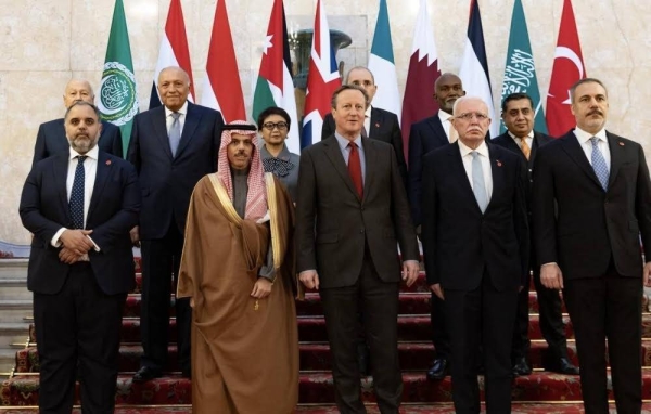 British Foreign Secretary David Cameron is flanked by Saudi Foreign Minister Prince Faisal bin Farhan and members of the Islamic Ministerial Committee delegation, in London on Wednesday.