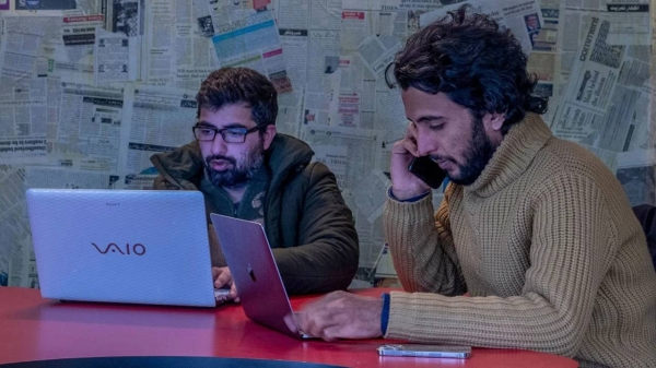 Fahad Shah, right, at his office in Srinagar, Indian controlled Kashmir on January 21, 2022