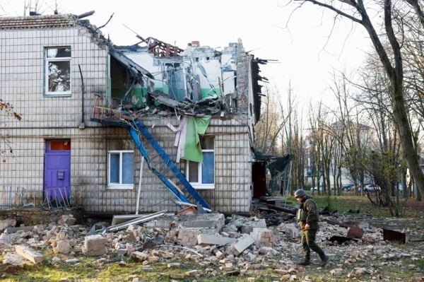 A police officer walks past a kindergarten that was heavily damaged by a drone strike. with a hollowed-out side. — courtesy Reuters