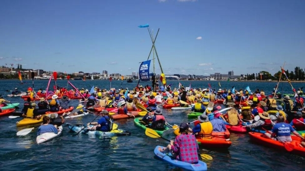 Hundreds of activists swam or used kayaks to occupy the shipping lane
