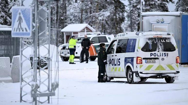 Finnish border guards and police at the Raja-Jooseppi international border crossing station in Inari, northern Finland, Friday