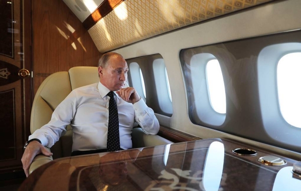 Russia's President Vladimir Putin aboard a plane on his way to the Russian Hmeimim air base in Syria.