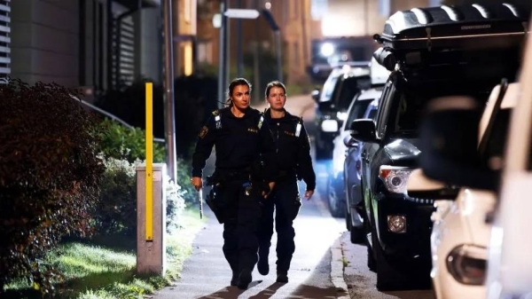 Police patrol the streets after a man was shot dead in September in a suburb south of Stockholm
