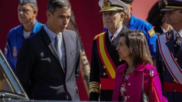 Spain's Prime Minister Pedro Sanchez, left, talks with Defense Minister Margarita Robles