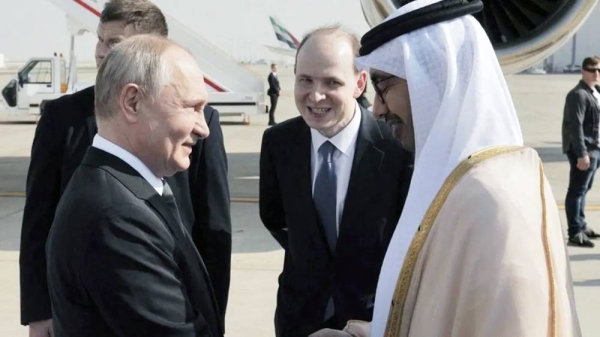 Vladimir Putin is welcomed by UAE Minister of Foreign Affairs Sheikh Abdullah Bin Zayed Bin Sultan Al Nahyan at the Abu Dhabi International Airport. — courtesy Reuters