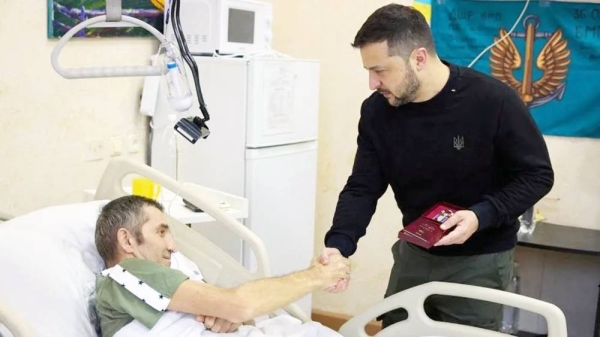 Ukraine's President Volodymyr Zelensky awards an injured Ukrainian serviceman in a hospital, on Day of the Ukrainian Armed Forces, amid Russia's attack on Ukraine, in Kyiv. — courtesy Ukrainian Presidency via Reuters