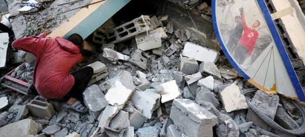People search for their belongings in the rubble in the Nuseirat refugee camp in Gaza. — courtesy UNRWA/Ashraf Amra
