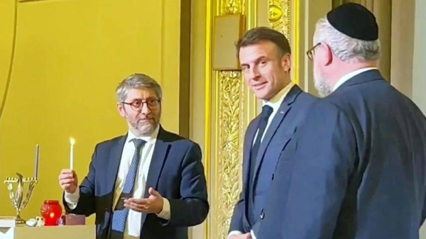 President Emmanuel Macron looked on as France’s Chief Rabbi Haïm Korsia lit a candle for the first night of Hanukkah. —courtesy Rabbi Mendel Samama/@EURORabbi