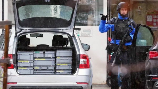 Armed police officer after a shooting in the Swiss town of Sion on Monday. — courtesy Reuters