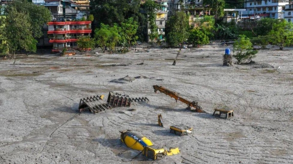 Construction vehicles covered in debris caused by the flash floods in October