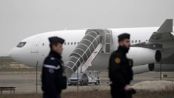 Gendarmes patrol by the plane grounded by police based that it could be carrying trafficking victims, at the Vary airport