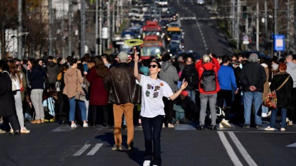 Students block one of the main streets during a protest in central Belgrade, on December 25, 2023, a week after the parliamentary and local elections in Serbia