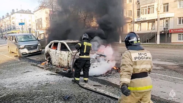 In this photo taken from video released by Russia Emergency Situations Ministry telegram channel on Saturday, firefighters extinguish burning cars after shelling in Belgorod, Russia. — courtesy Russia Emergency Situations Ministry telegram channel/AP