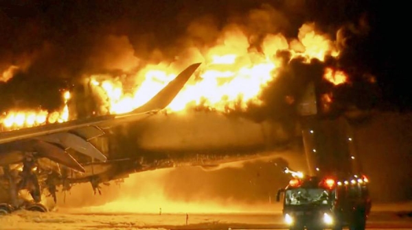 File pictures of plane on fire on Tokyo runway.