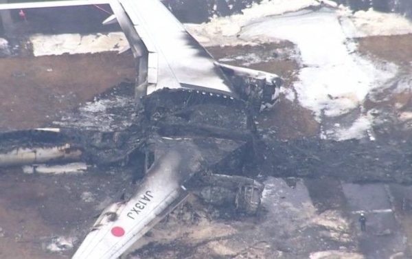 Aerial footage shows burned out shell of Japan plane
