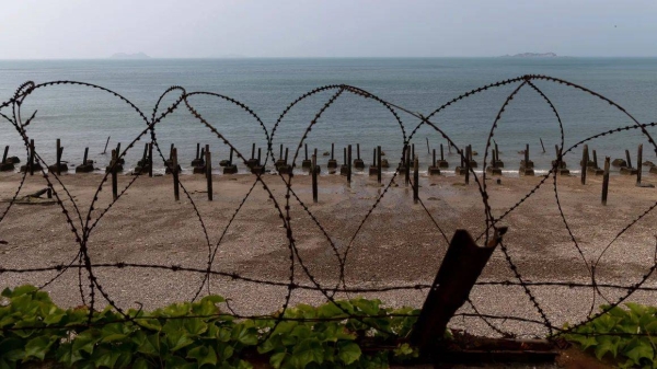 Metal spikes and razor wire sit along a beach on Yeonpyeong Island, South Korea, on June 26, 2020