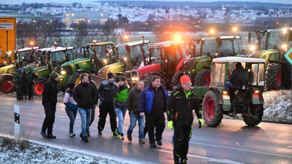 Farmers block the access road to the A8 highway with tractors in Neuhausen, Monday