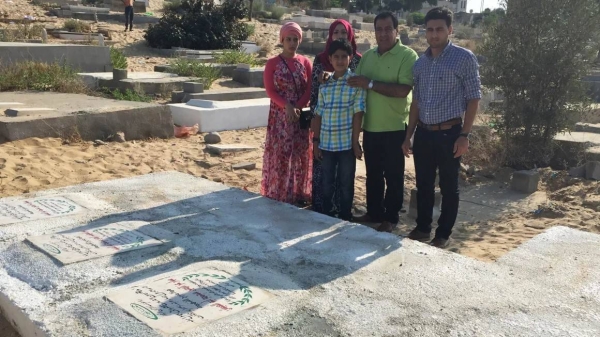 Dr. Izzeldin Abuelaish, with his children, visiting the graves of his daughters who were killed in 2009. Almost 15 years later, he is again mourning the deaths of his extended family in Gaza