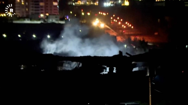 Smoke rises from a building hit by a strike in Erbil, Iraq on January 16, 2024