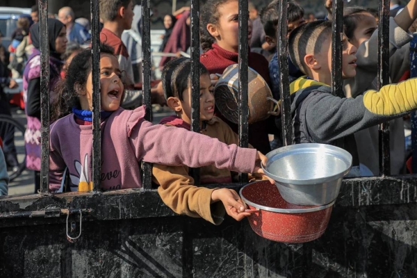 Children try to get food relief in the southern Gaza Strip city of Rafah, on December 31, 2023