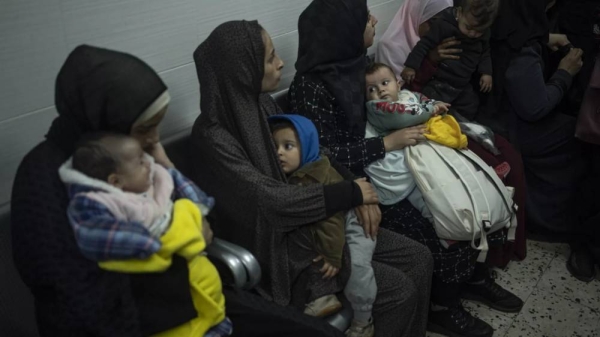 Palestinians line up with their children to receive vaccination against diseases, which recently entered Gaza as part of aid, in Rafah, southern Gaza Strip