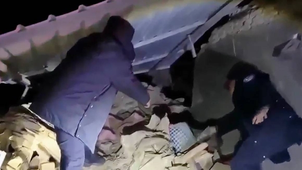 Rescuers search for survivors under the rubble after an earthquake struck China's far western region of Xinjiang on January 23, 2024